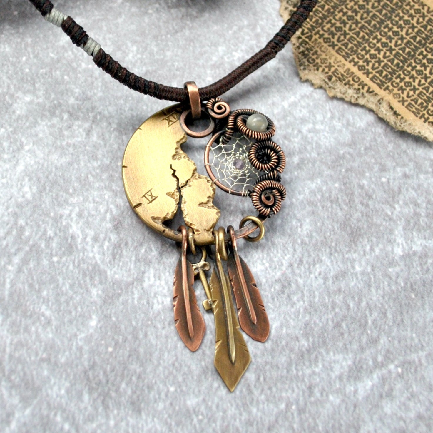Steampunk, dystopian necklace pendant with dreamcatcher, wire wrapped gemstones and broken clock face. Metal feathers and small key