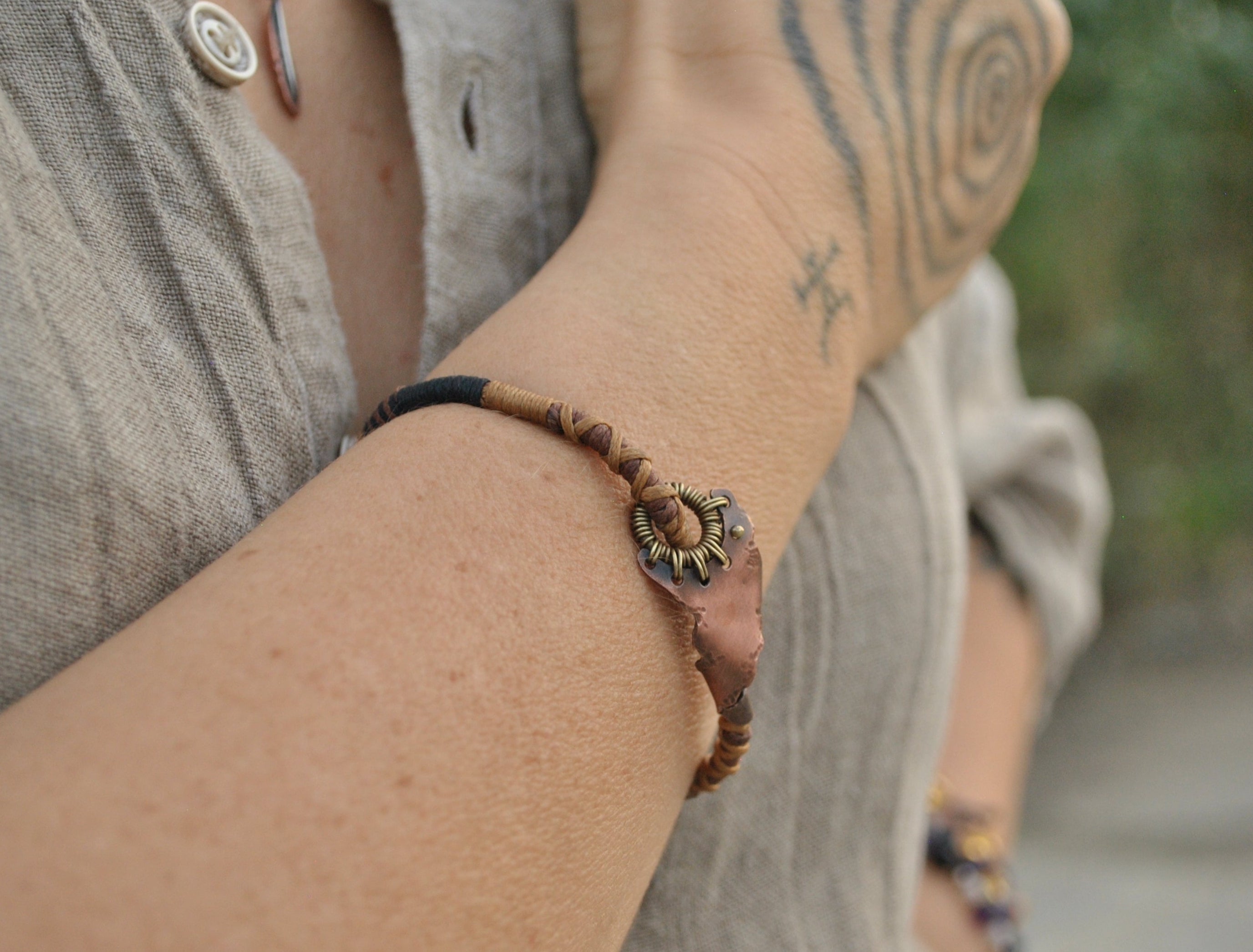 Wire wrapped dystopian style bracelet with braided macrame chords by Spiral Roads Jewellery