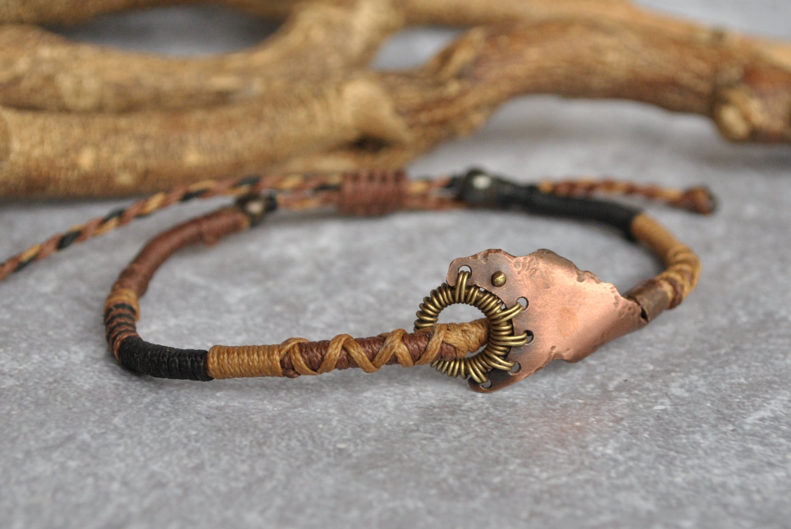Wire wrapped dystopian style bracelet with braided macrame chords