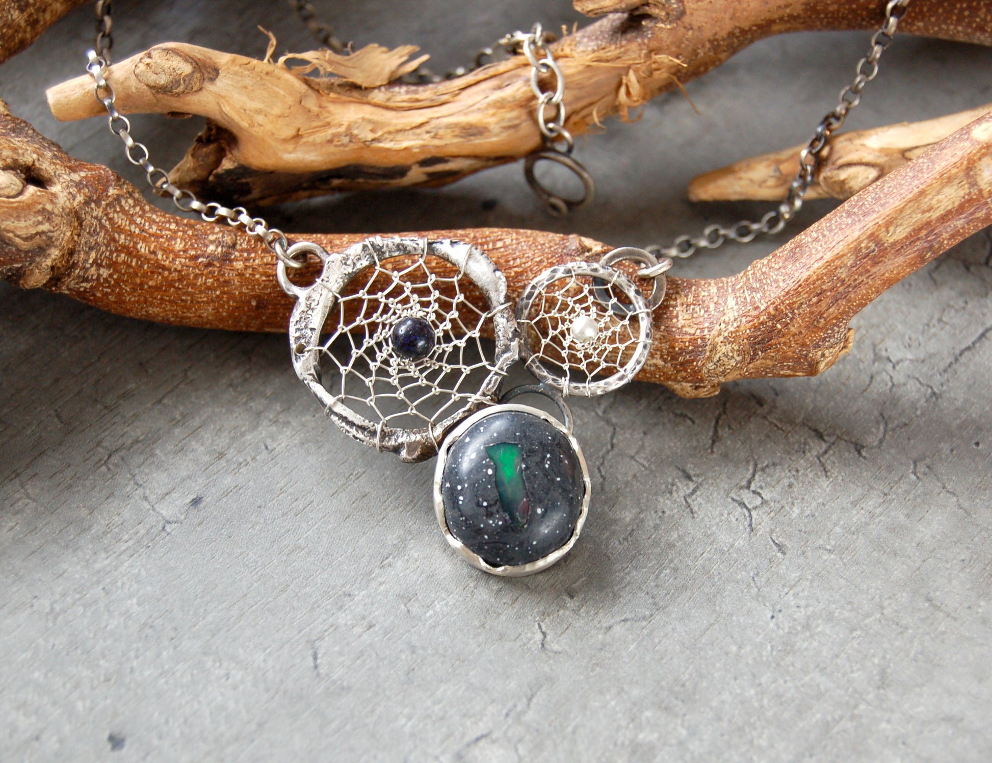 Boho style dream catcher pendant with boulder opal. Textured sterling silver necklace