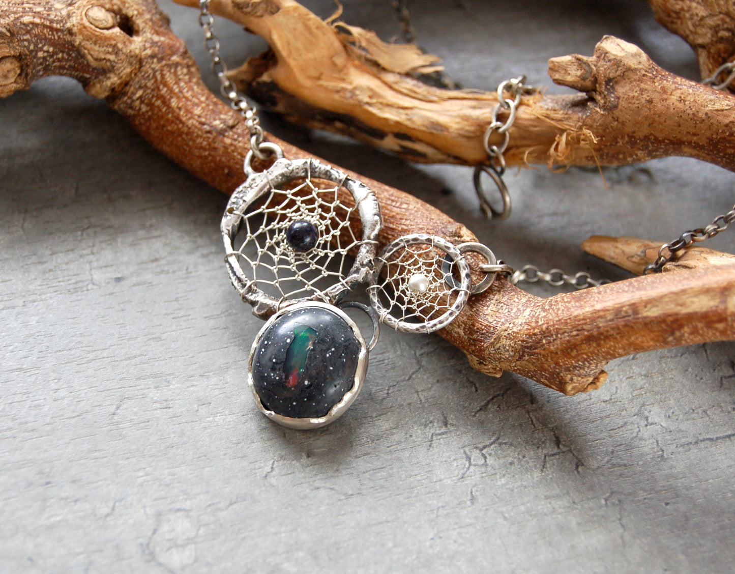 Boho style dream catcher pendant with boulder opal. Textured sterling silver necklace