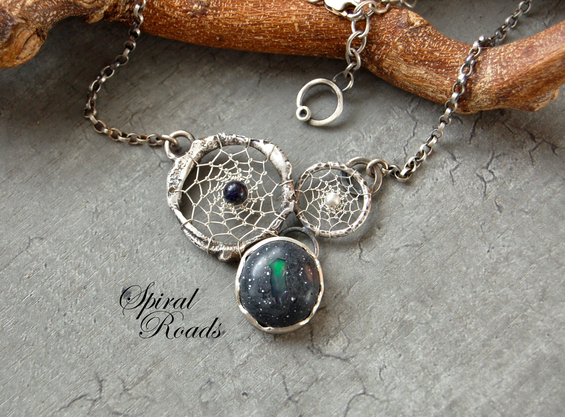 Boho style dream catcher pendant with boulder opal. Textured sterling silver necklace