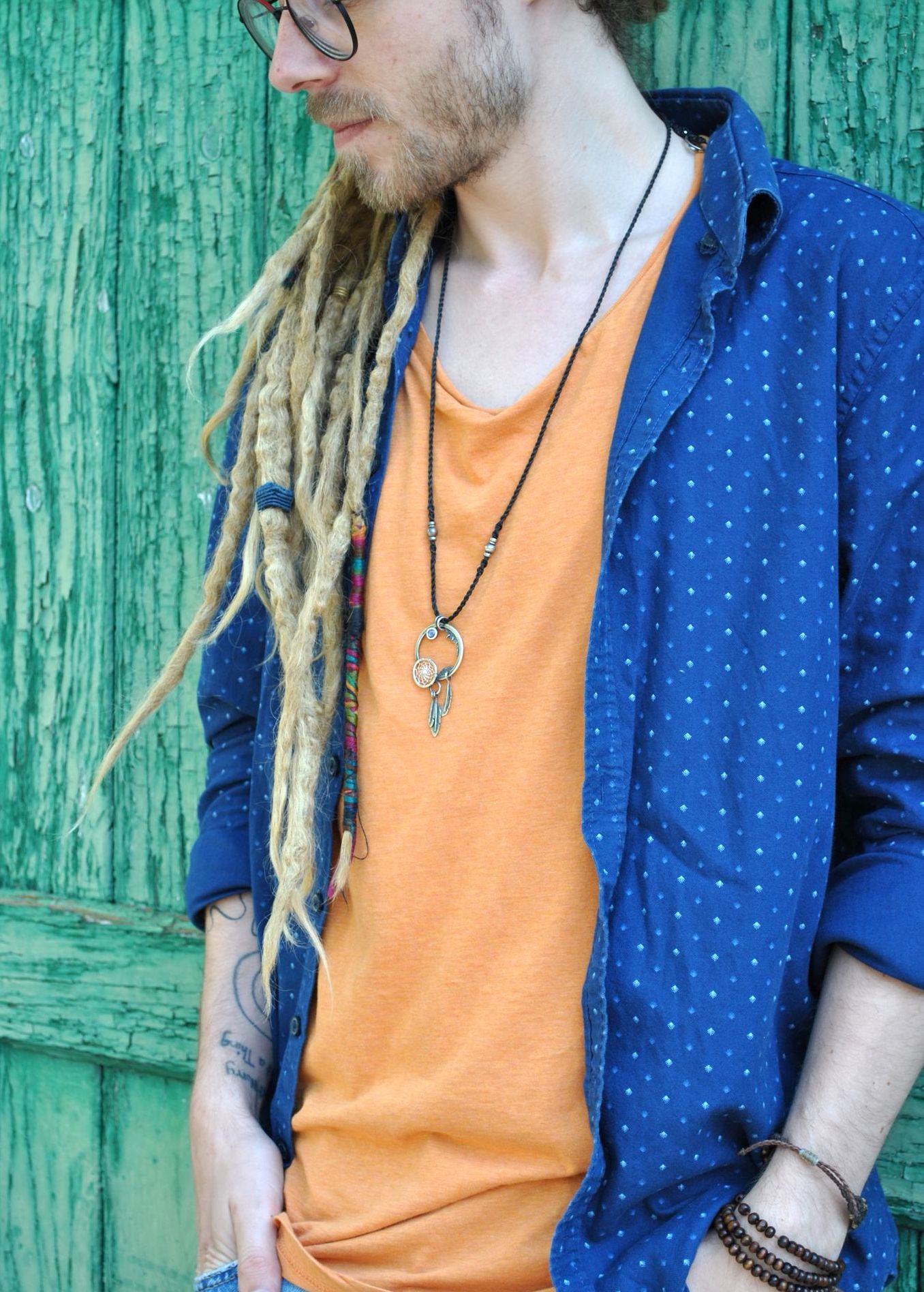blonde dreadlocks and silver dream catcher necklace
